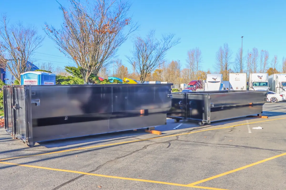 Professional dumpster rental service with roll-off container on residential driveway in Potomac Mills